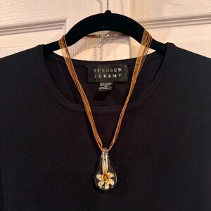 Fashion necklace.  Flower encased in glass